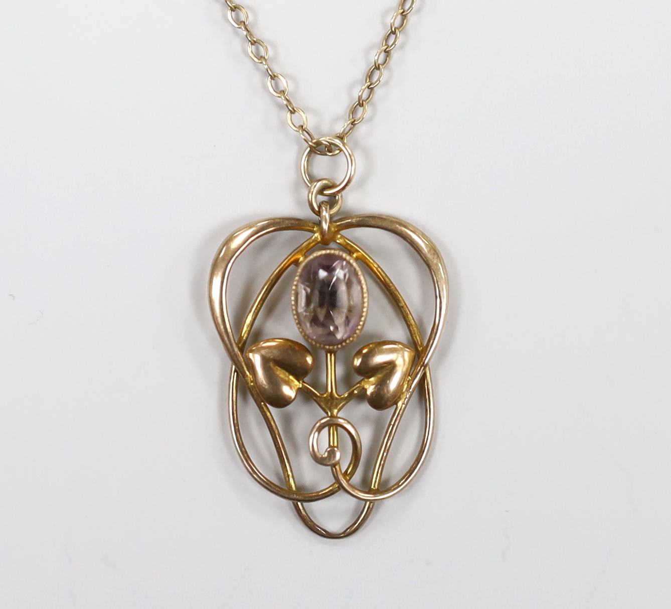 An Edwardian Art Nouveau 9ct and pale amethyst set pendant, on a 9ct chain, overall 52cm, gross weight 3.1 grams.